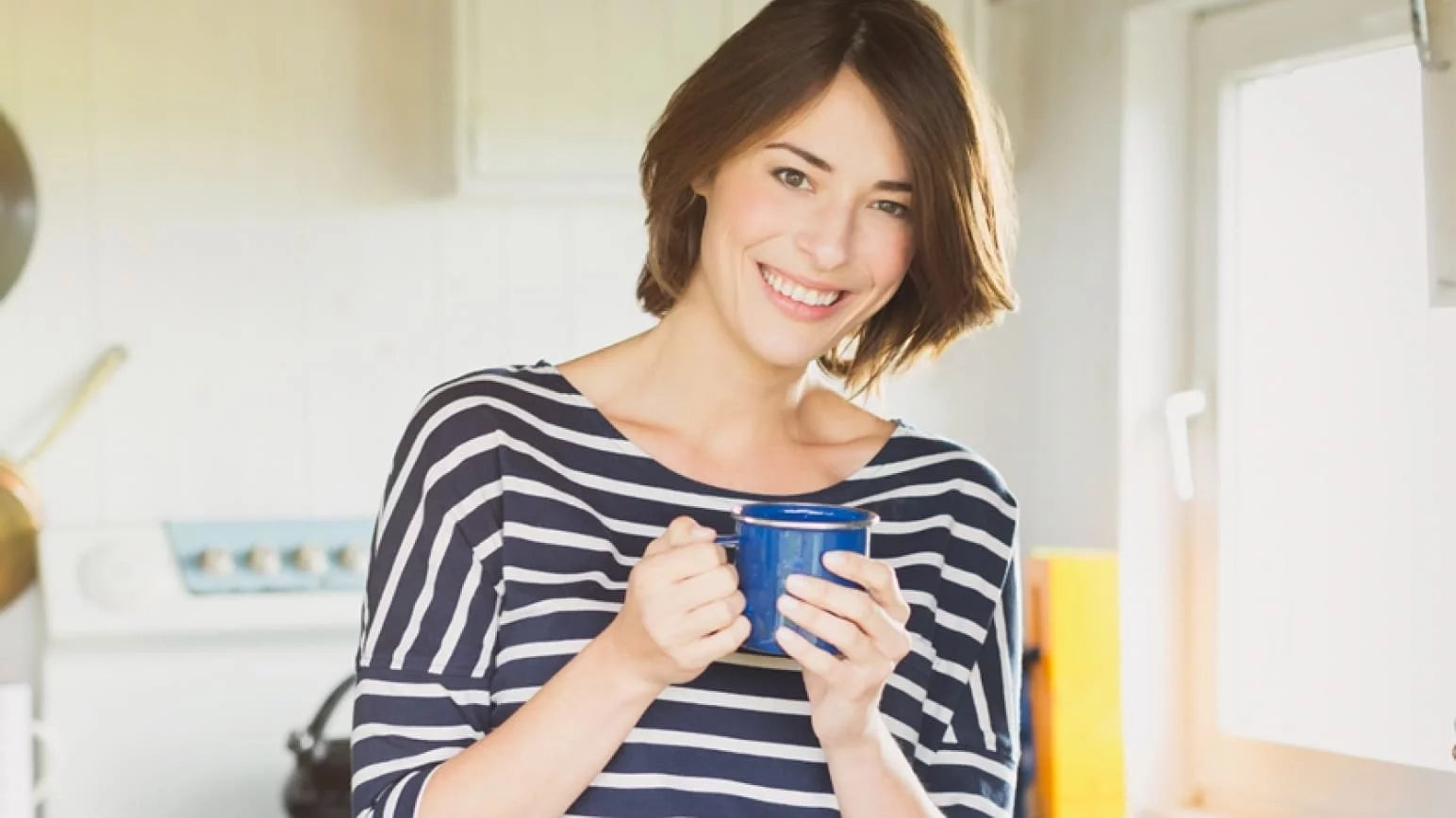 mujer feliz sujetando una taza